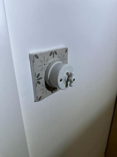 a lightswitch on a wall with a metal box at Habitación Montgros en Casa Camí de les Aigües Monistrol de Montserrat in Monistrol