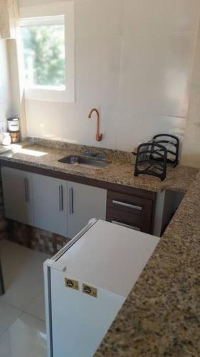 a kitchen with a sink and a counter top at apartamento com Deck e vista mar - Loft Rocha in Rio de Janeiro