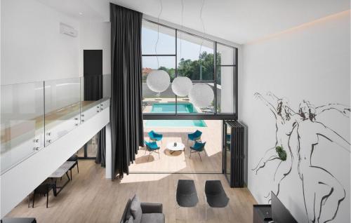 a living room with a table and chairs and a pool at Villa Eden in Ližnjan