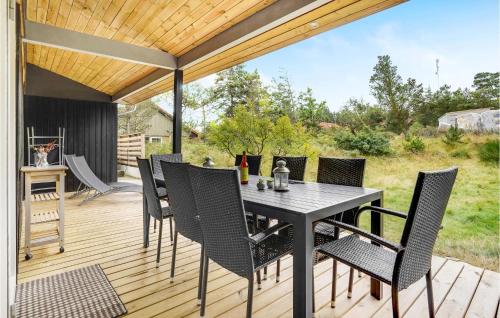 a patio with a table and chairs on a deck at Holiday Home Nørre Nebel 57 in Nymindegab