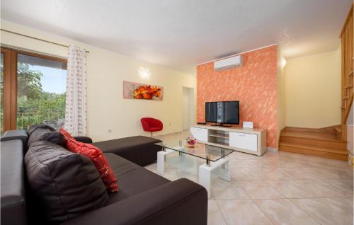 salon z kanapą i telewizorem w obiekcie Three-Bedroom Holiday Home In Tinjan w mieście Tinjan