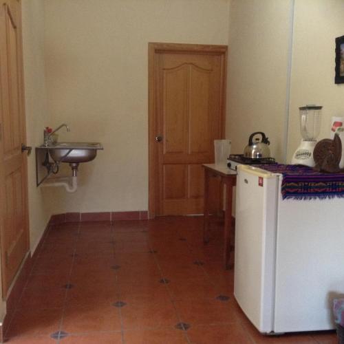a small kitchen with a sink and a refrigerator at Loft El Rosario in Tlayacapan