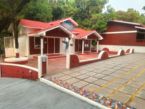 a building with a lot of balls in front of it at Shantadurga Beachside Homestay in Guhagar