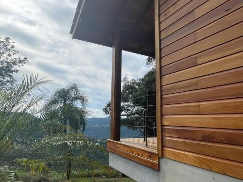 a window on the side of a house with a view at Chalé dos Coqueiros em Nova Petrópolis in Nova Petrópolis
