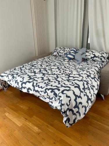 a bed with a black and white comforter on it at Casalura in Polignano a Mare