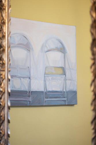 a painting of two chairs on a wall at Vierzigerhof in Langenlois