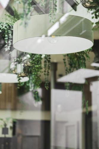 a light hanging from a ceiling with plants at Vierzigerhof in Langenlois