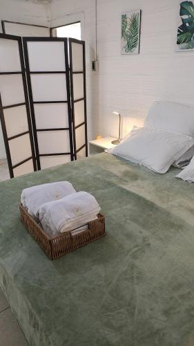 a bed with two towels sitting on top of it at Departamento equipado, centrico, cochera cubierta Sarmiento265apart D18 in San Fernando del Valle de Catamarca