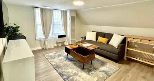 a living room with a couch and a table at Chic, Cozy & New Prime location with AC, Street Parking #4 in Renton