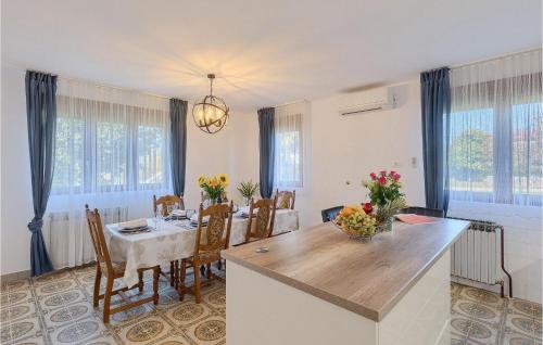 a kitchen and dining room with a table and chairs at Villa Mendula in Potpićan