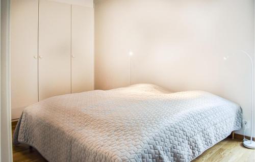 a small bedroom with a bed and a closet at Beautiful Home In Holmsjö With Sauna in Holmsjö