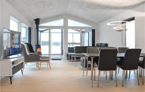 a dining room with a table and chairs at Four-Bedroom Holiday Home In Ringkobing in Ringkøbing