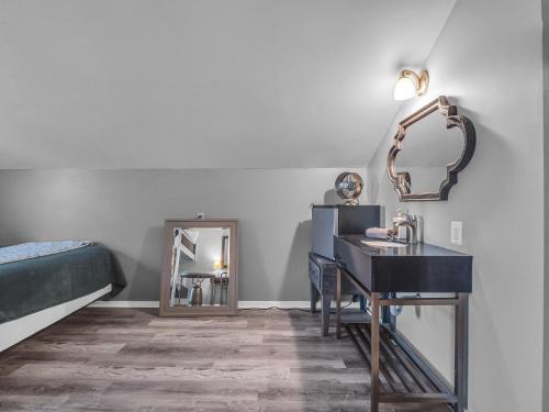 a bedroom with a sink and a bed and a mirror at Timberline Lodge in Ellicottville