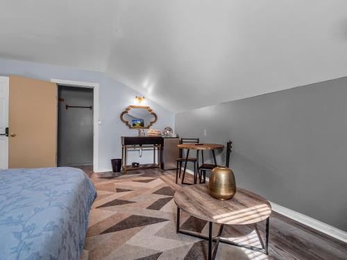 a bedroom with a bed and a table and a mirror at Timberline Lodge in Ellicottville