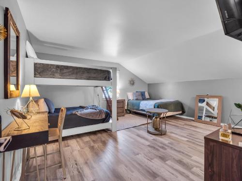 a bedroom with two bunk beds and a desk at Timberline Lodge in Ellicottville