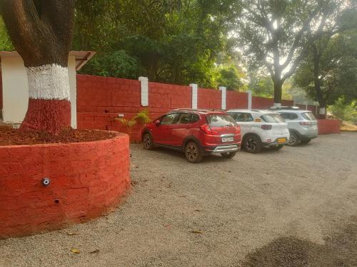 a group of cars parked in a parking lot at Shantadurga Beachside Homestay in Guhagar
