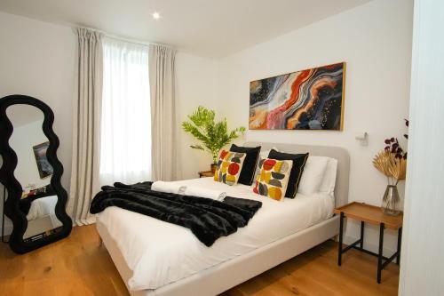 a white couch with pillows on it in a room at SUNRISE 1 Bedroom Apartment in Central Eastbourne in Eastbourne