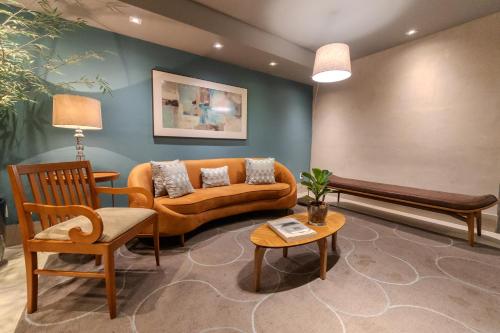 a living room with a couch and a table at Hotel Heritage in Sao Paulo