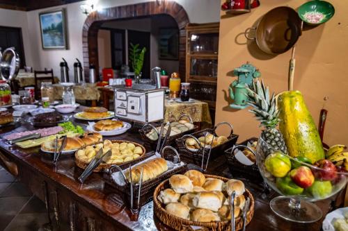 a table topped with baskets of bread and other foods at Hotel Pantanal Mato Grosso in Poconé