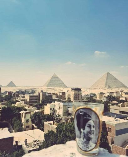 a cup with a picture of a man with pyramids in the background at Eyad Pyramids view in Cairo