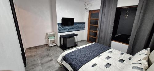 a bedroom with a bed and a fireplace and a television at Jukskei Big 5 - Leopard in Randburg