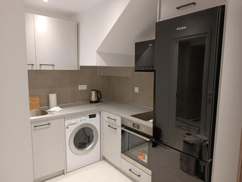 a kitchen with a washing machine and a washer at Tatiana's Town Studio in Corfu
