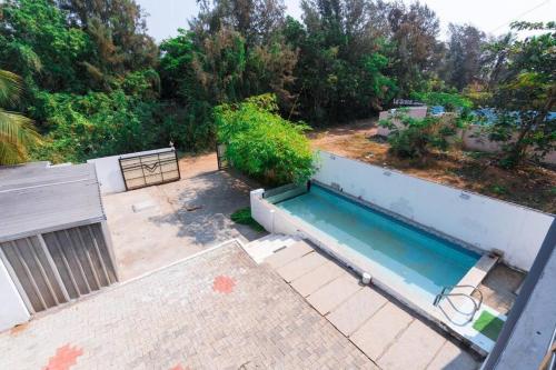 an overhead view of a swimming pool in a yard at GMT Villa Kovalam , ECR in Covelong