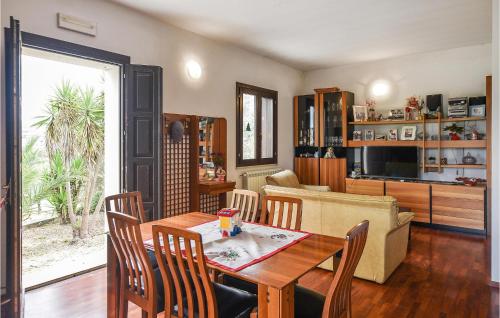 a living room with a table and a couch at Cozy Home In Monterosso Almo in Monterosso Almo