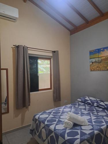 a bedroom with a bed with towels on it at Casa do Mar & Ane Ilhabela in Ilhabela