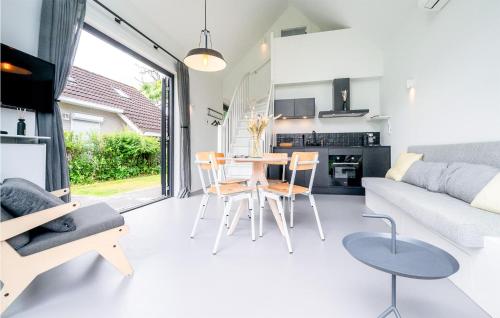 a kitchen and living room with a table and chairs at Pet Friendly Home In Vlissingen in Vlissingen