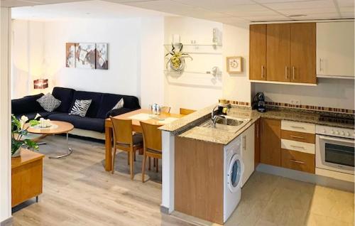 a kitchen and a living room with a couch at 3 Bedroom Cozy Apartment In La Ràpita in Sant Carles de la Ràpita
