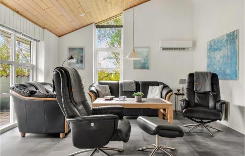a living room with leather chairs and a table at 4 Bedroom Lovely Home In Vestervig in Vestervig