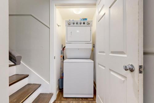 a small white refrigerator in a small kitchen at 126 Grand Pavilion in Isle of Palms