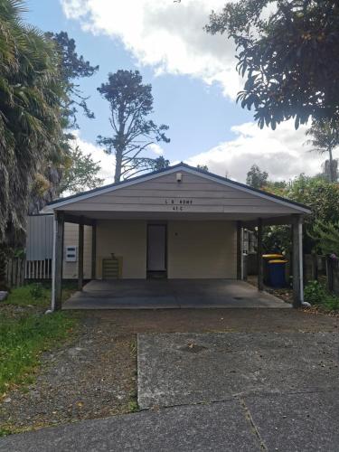a building with a garage with a roof at LD Home in Auckland