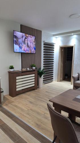 a living room with a flat screen tv on a wall at Apartments Green Beograd in Borča