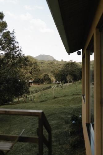 a view of a field from the porch of a house at Cabanas Grande Passo in Quatro Barras