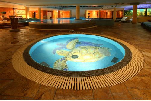 a turtle swimming in a pool in a hotel lobby at Grand Rose SPA Hotel in Kuressaare