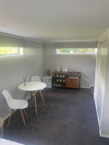 a room with a table and two chairs and a table at The Avenues Hideaway in Tauranga