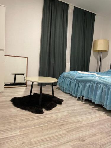 a room with a bed and a table next to a bed at APARTMAN Visoko in Visoko
