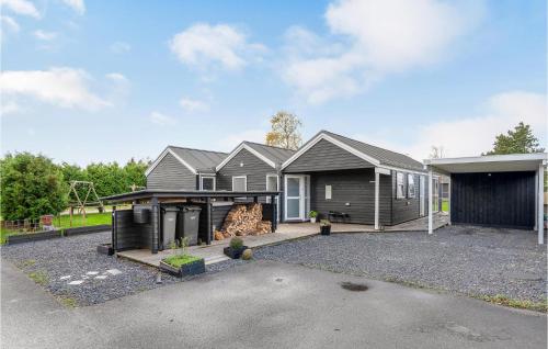 a house with a garage and a driveway at Amazing Home In Skibby With Kitchen in Skibby