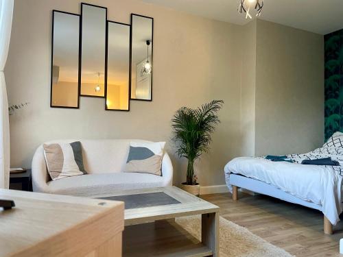 a living room with a couch and a table at Le P’tit B - Quartier Saint-Michel/Centre Ville in Saint-Brieuc