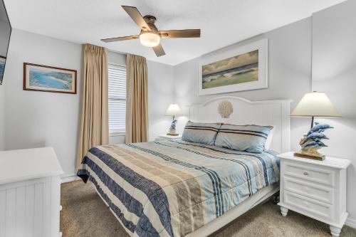 a bedroom with a bed and a ceiling fan at Royal Palms 907 in Gulf Shores