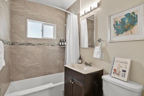a bathroom with a sink and a toilet and a shower at Riviera Bay View Dream - Private patio with bay view and parking in San Diego