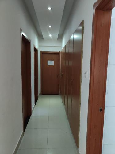 a corridor with wooden doors at Kilamba Apart VP in Camama