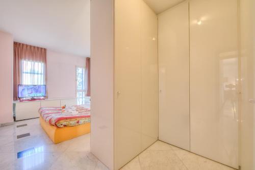 a bedroom with a bed and a glass wall at Residenza Borgo Rustico with Pool - Happy Rentals in Collina d'Oro