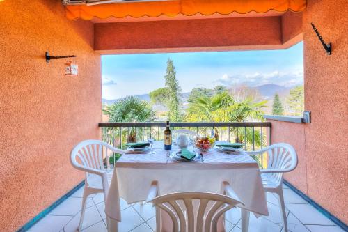 a table and chairs on a balcony with a view at Residenza Borgo Rustico with Pool - Happy Rentals in Collina d'Oro