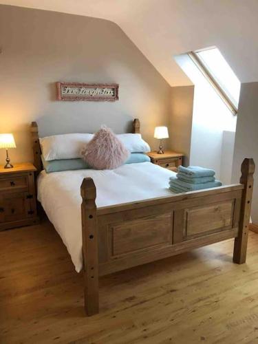 a bedroom with a large bed with two night stands at Beautiful one bed apartment in excellent location in Spiddal