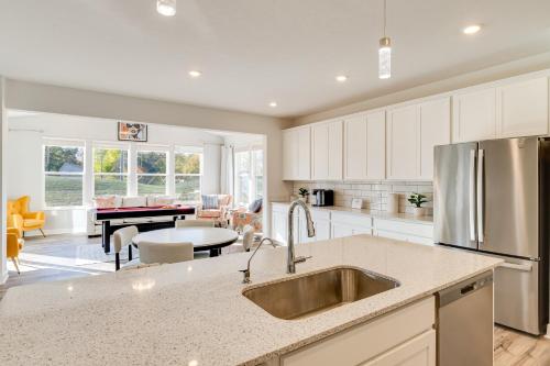 a kitchen with a sink and a living room at 4 Mi to Dtwn Danville Home with Patio and Yard in Danville