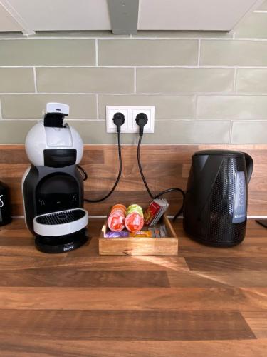 a coffee maker and a box of food next to a microwave at Morning Glory Huisje Jasmijn in Beekbergen