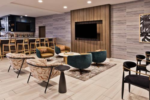 a bar in a hotel lobby with chairs and a table at Hilton Garden Inn Montgomery - EastChase in Montgomery
